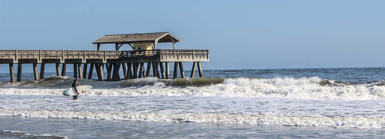 Surfer Wading Out In Front Of Tybee Pier